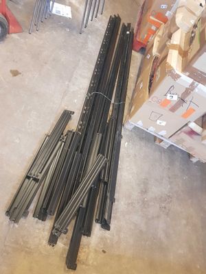 a pile of steel rods sitting on the floor in a warehouse