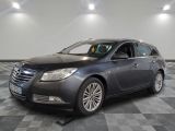 a picture of a grey car parked in a garage