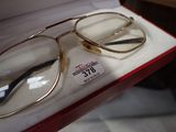 pair of glasses in a box with price tag on it