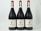 three bottles of wine sitting on top of a white table