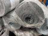 a pile of rolls of wire mesh wrapped in plastic