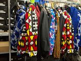 a lot of clothes hanging on a rack in a store