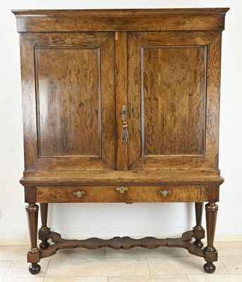 a wooden cabinet with two drawers on top of it