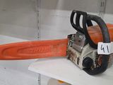a chainsaw that is sitting on a shelf in a room