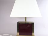 a close up of a lamp with a white shade on a table
