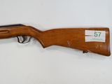 a rifle that is on display on a white surface