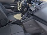 the interior of a car with the front seats down and a steering wheel in the center