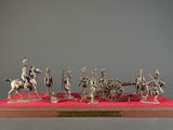 silver figurine of a group of soldiers on horses and a carriage
