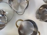 a lot of pots and pans that are on the table