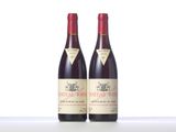two bottles of red wine sitting next to each other on a table