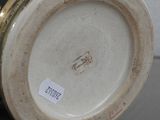 a close up of a vase with a tag on it