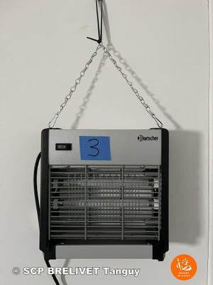 a black and white photo of a hanging fan on a wall