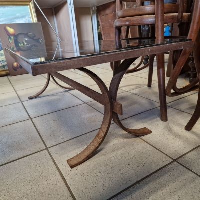a glass table with a wooden base and a glass top