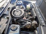 a car engine with the hood up and the hood down