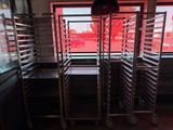 a rack with trays of food in front of a window