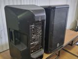 two speakers sitting on a table in a room