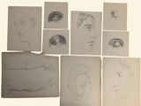 several sketches of a woman ' s face are shown on a sheet of paper