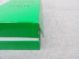 a green box that is open on a white table