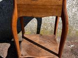 a small wooden table with a shelf on it