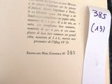 an open book with a piece of paper on top of it