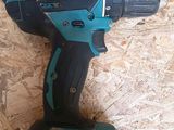 a close up of a cordless drill on a piece of wood