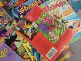 a lot of comic books sitting on a table