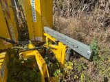 a yellow machine that is sitting in the grass