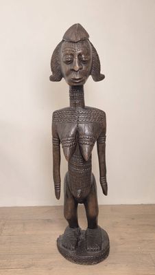 an image of a wooden statue of a woman standing on a wooden floor