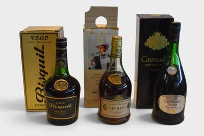 three bottles of alcohol are sitting next to a box of wine