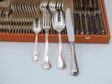 a lot of silverware in a box on the table