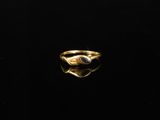 a gold ring with a blue stone in the center
