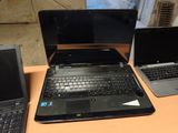 three laptops that are sitting on a table