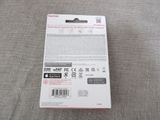 the back of a white box with a black and red sticker on it