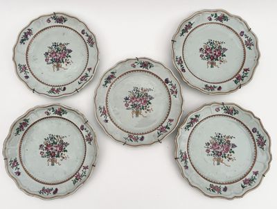 four plates with floral designs on them sitting on a white surface