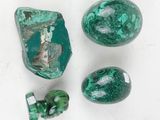 three pieces of green marble on a white surface