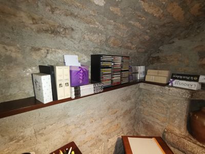 many books on the shelves in the corner of the room