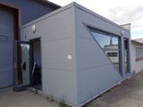 a small building with a door and a window on the side of it