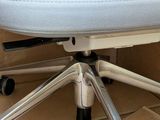 a white office chair that is sitting on a cardboard box