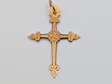 a gold cross with a flower design on it