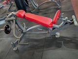 a red bench in the middle of a gym room