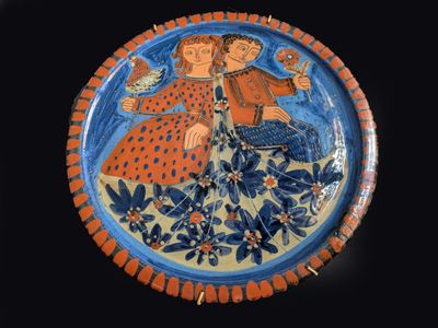 a blue and orange plate with a picture of a man and a woman on it