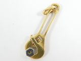 yellow gold plated wrench brooch pin with a black eye
