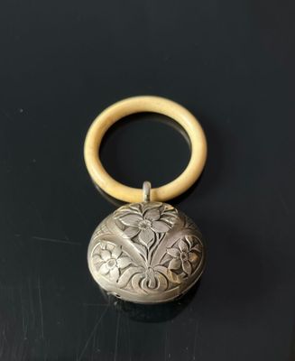 an antique silver locke with a wooden handle on a black surface