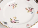 two plates with flowers on them on a table