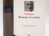 two books sitting next to each other on a white surface