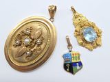 three pieces of jewelry are shown on a white surface