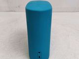 a blue speaker that is sitting on a table