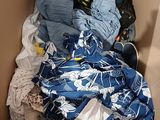 a cardboard box filled with clothes and clothing items