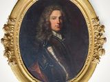 portrait d'un homme en armure dans un cadre ovale doré
