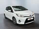 the toyota yaris is parked in a large white room